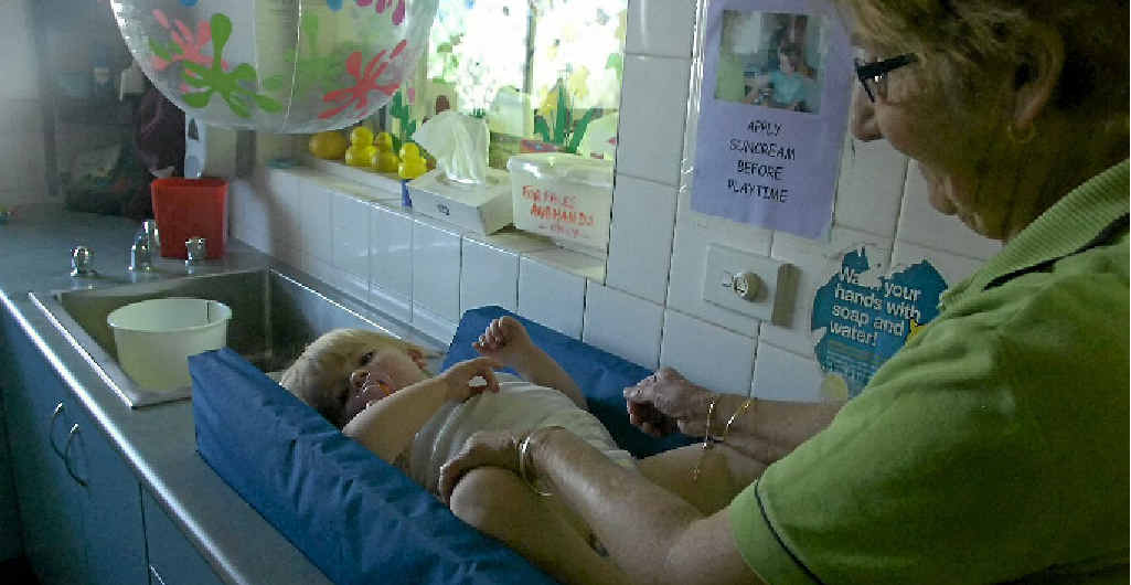 Stepping Stones group leader Gayle Ness changes one-year-old Milla Woodrow’s nappy. Stepping Stones group leader Gayle Ness changes one-year-old Milla Woodrow’s nappy.